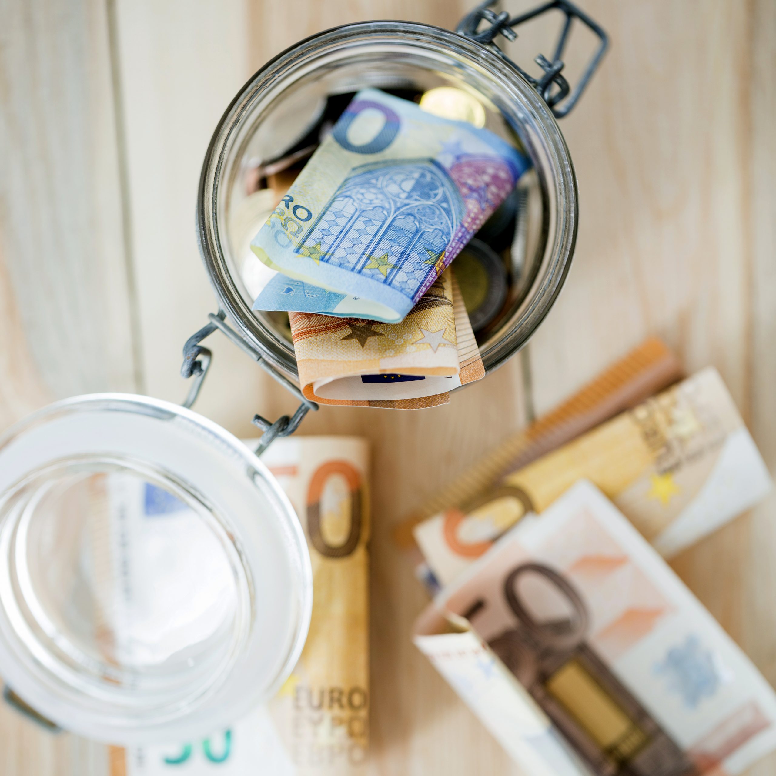 overhead-view-euro-banknotes-open-glass-jar